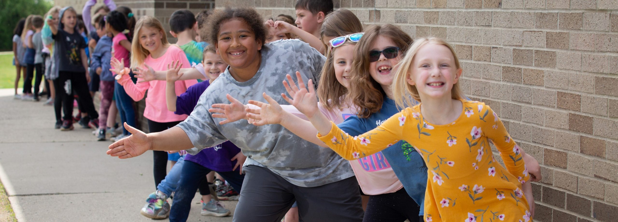 child being greeted by a line of adults